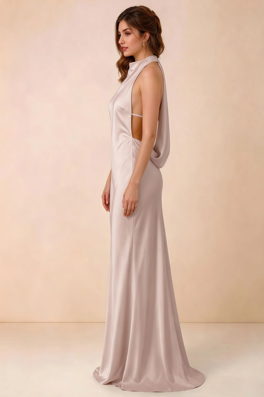 Side view of the Astrid blush satin maxi dress, showing the halter neckline, open sides and softly draped back.