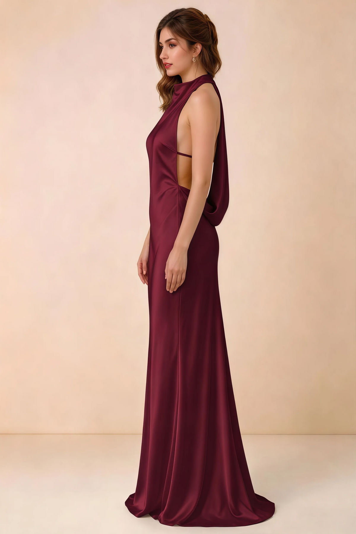 Side view of the Astrid burgundy satin maxi dress, showing the halter neckline, open sides and softly draped back.