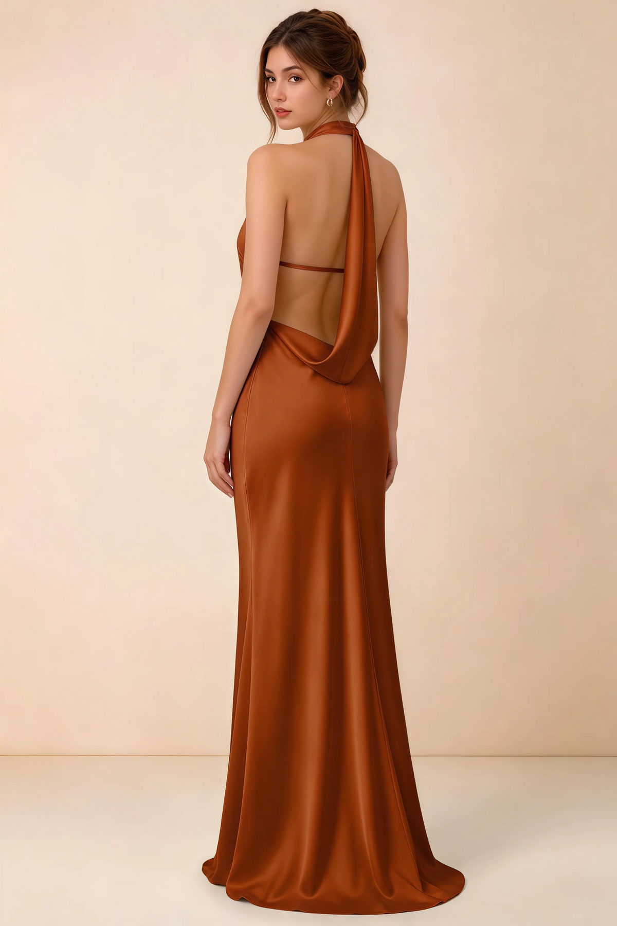 Back view of the Astrid burnt orange satin maxi dress, showing the low open back, slim horizontal strap and draped cowl panel.