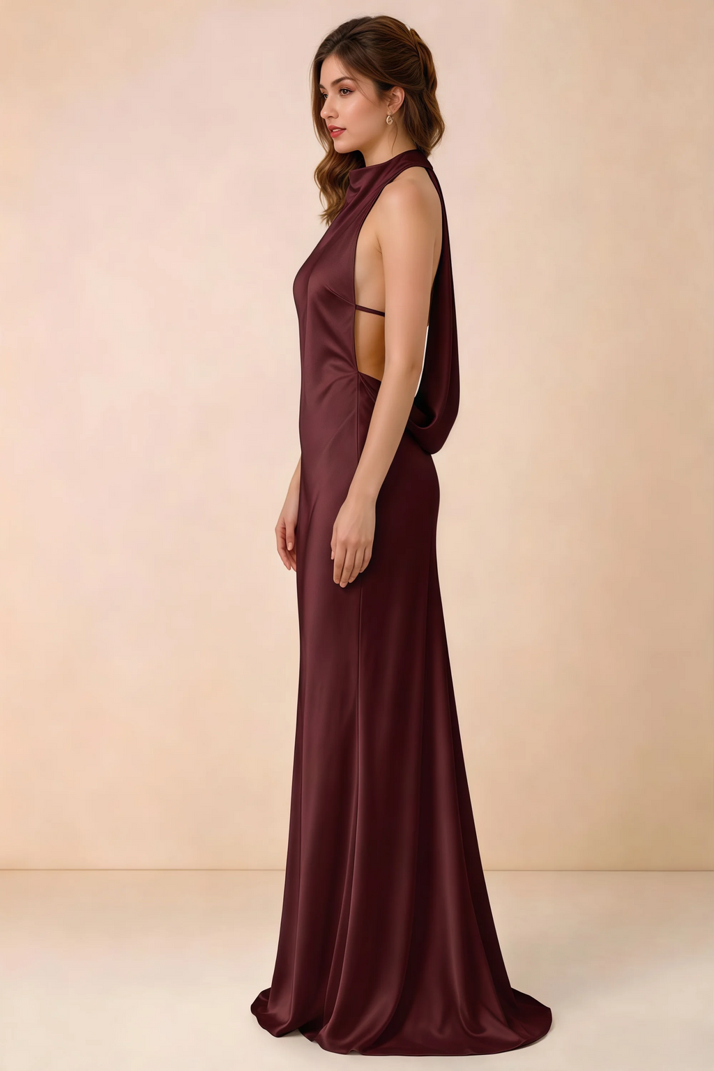 Side view of the Astrid cabernet satin maxi dress, showing the halter neckline, open sides and softly draped back.