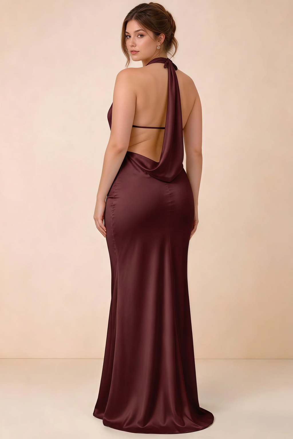 Rear three-quarter view of the Astrid cabernet satin maxi dress, showing the halter ties, slim back strap and cowl detail.