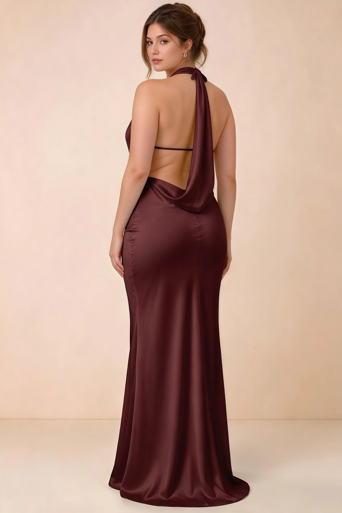 Rear three-quarter view of the Astrid cabernet satin maxi dress, showing the halter ties, slim back strap and cowl detail.