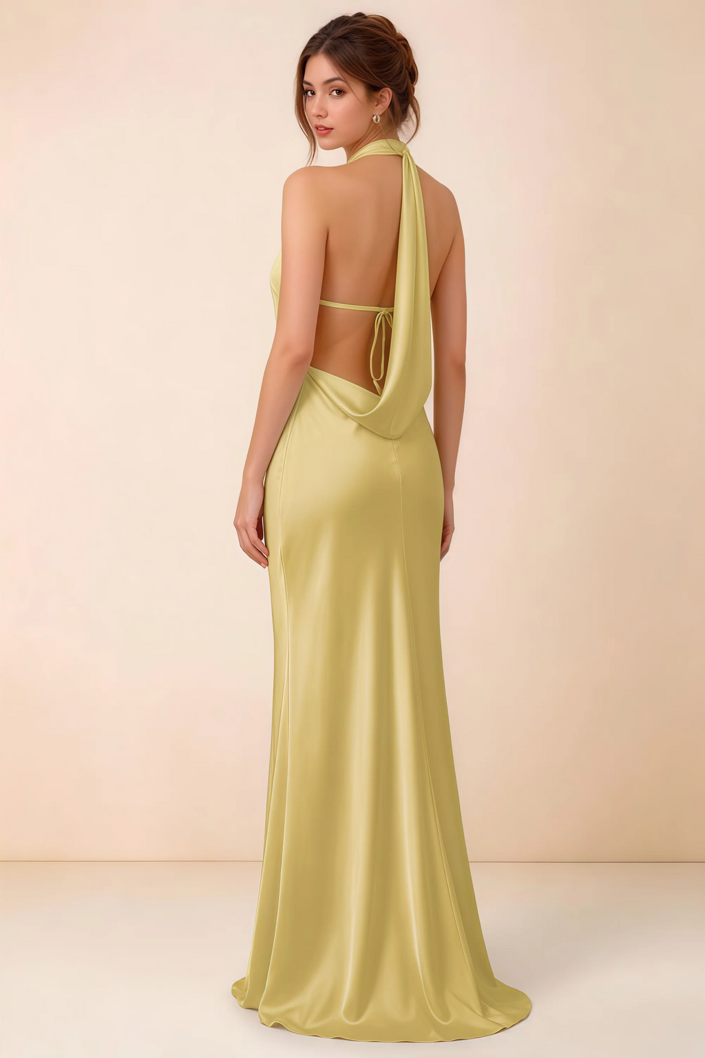 Back view of the Astrid canary satin maxi dress, showing the low open back, slim horizontal strap and draped cowl panel.