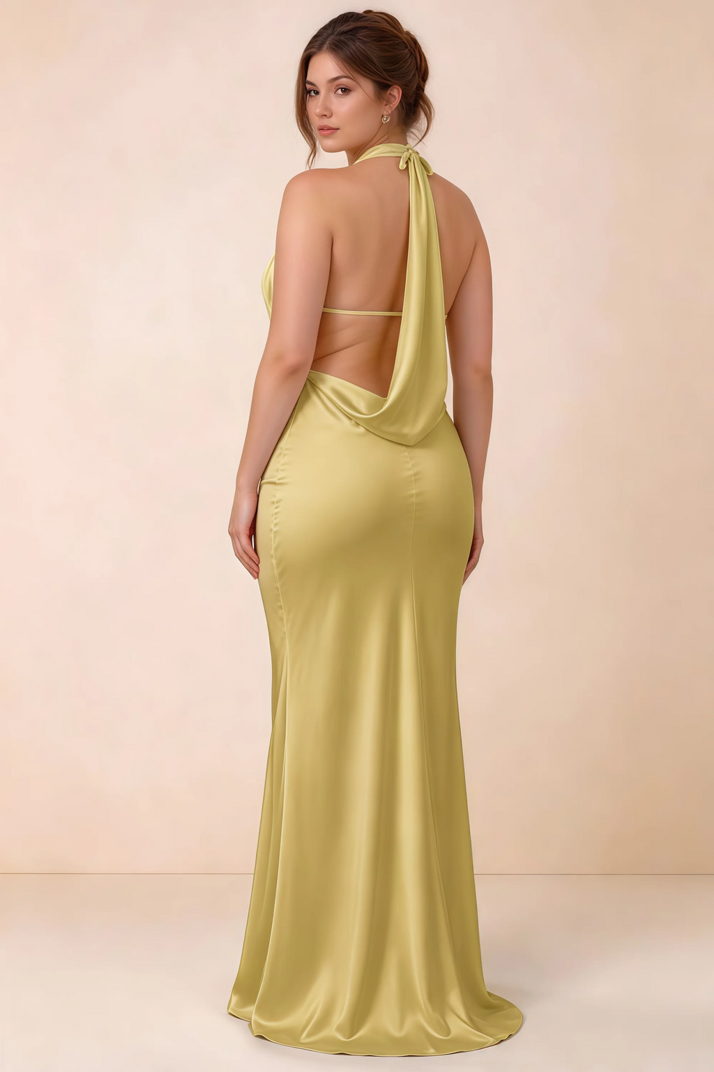 Rear three-quarter view of the Astrid canary satin maxi dress, showing the halter ties, slim back strap and cowl detail.