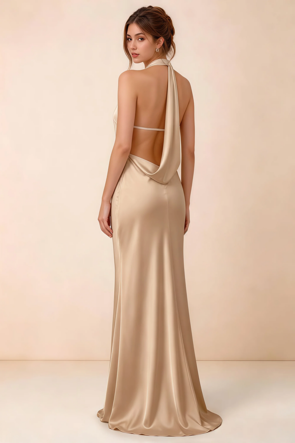 Back view of Astrid champagne satin halter maxi dress, highlighting the open draped back.