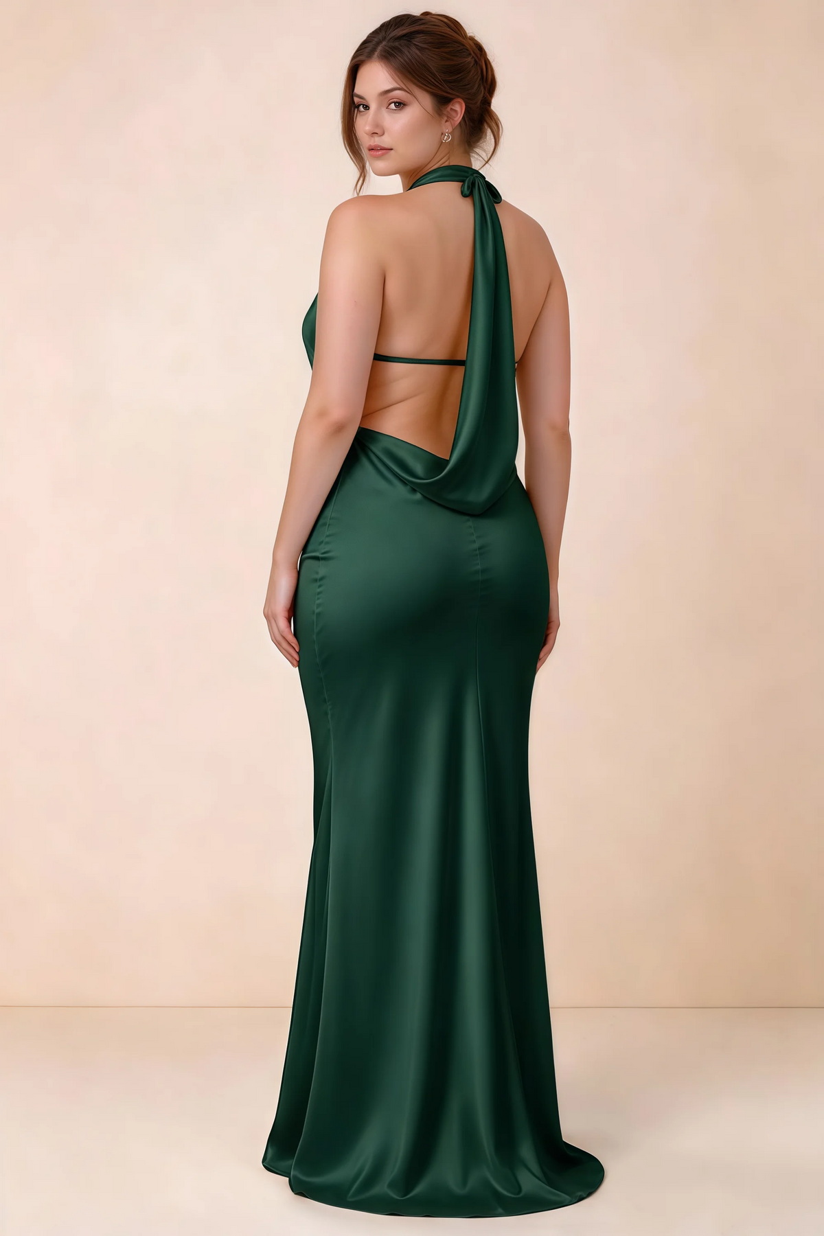 Three-quarter rear view of Astrid dark green satin halter maxi dress, showing the cowl back.
