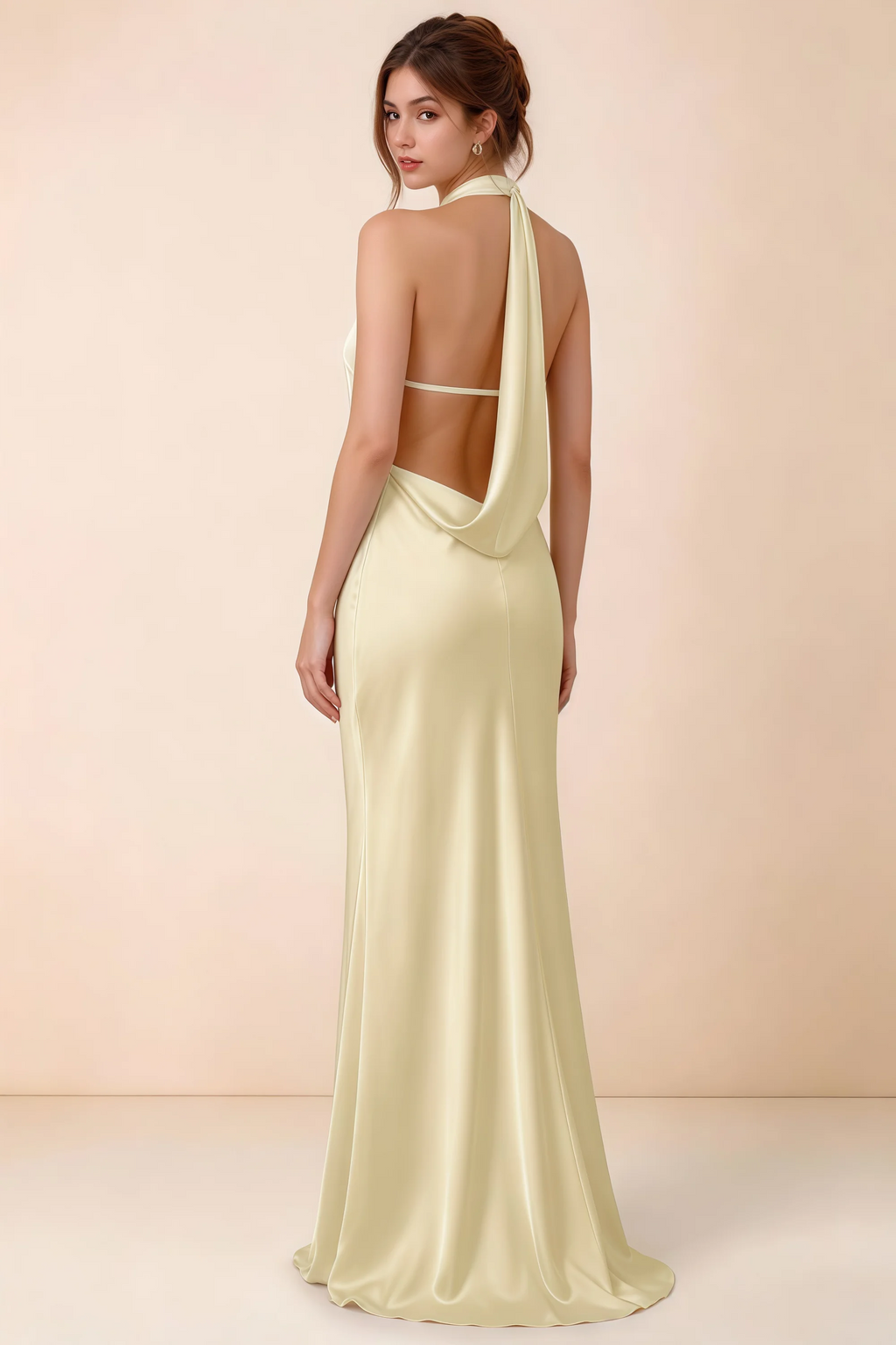 Back view of Astrid lemon satin halter maxi dress, highlighting the draped open back.