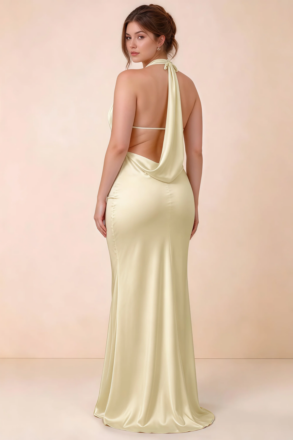 Rear three-quarter view of Astrid lemon satin halter maxi dress, highlighting the open back.