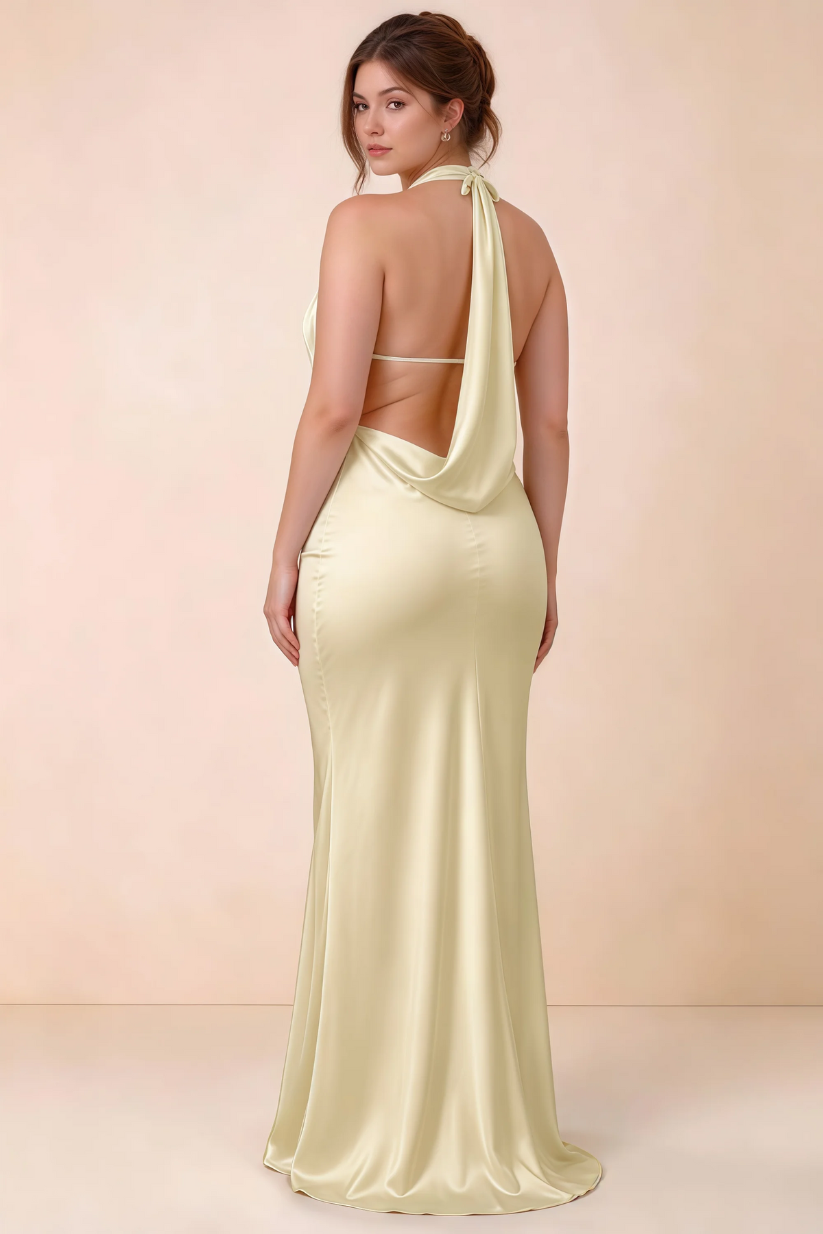 Rear three-quarter view of Astrid lemon satin halter maxi dress, highlighting the open back.