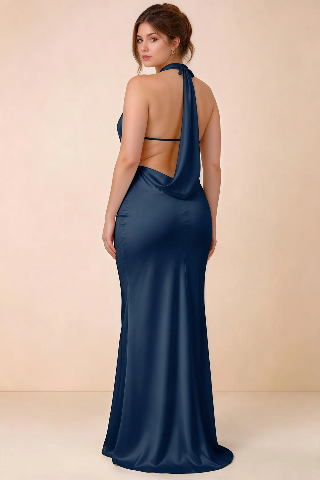 Rear three-quarter view of Astrid navy satin halter maxi dress, highlighting the open back.