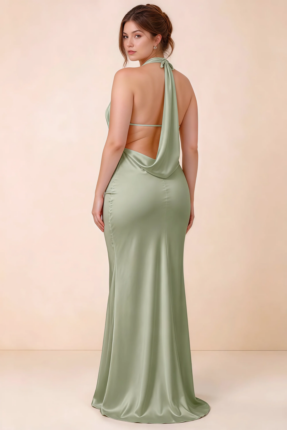 Rear three-quarter view of Astrid sage green satin halter maxi dress, highlighting the open back.