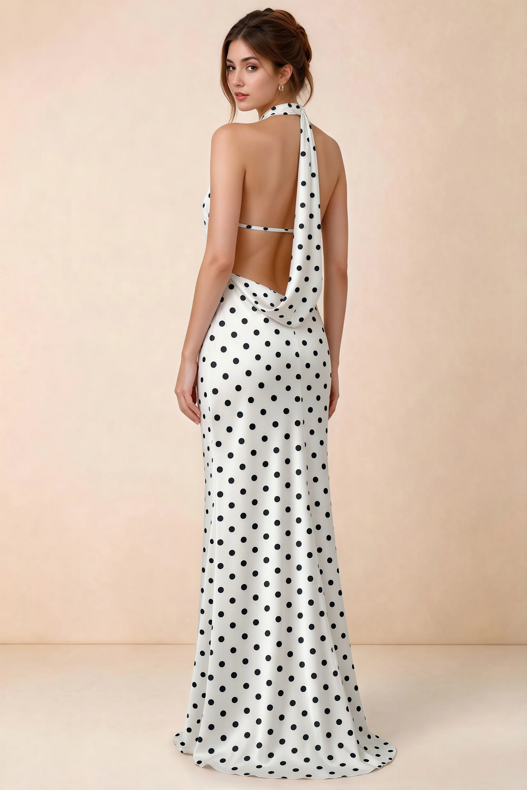 Back view of Astrid white polka dot halter maxi dress, highlighting the open draped back.
