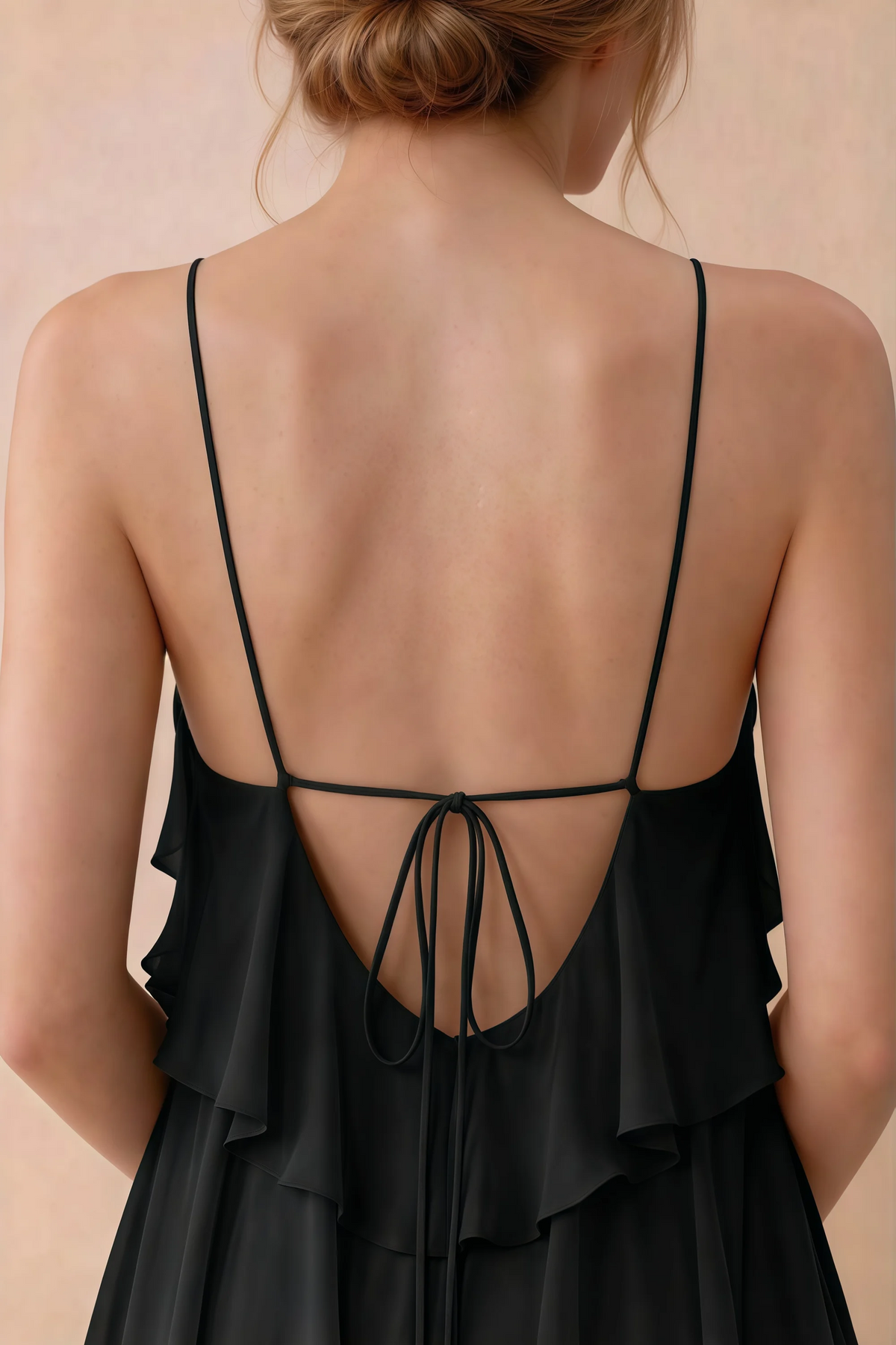 Close-up of Audrey black open back with fine straps tied in a small bow