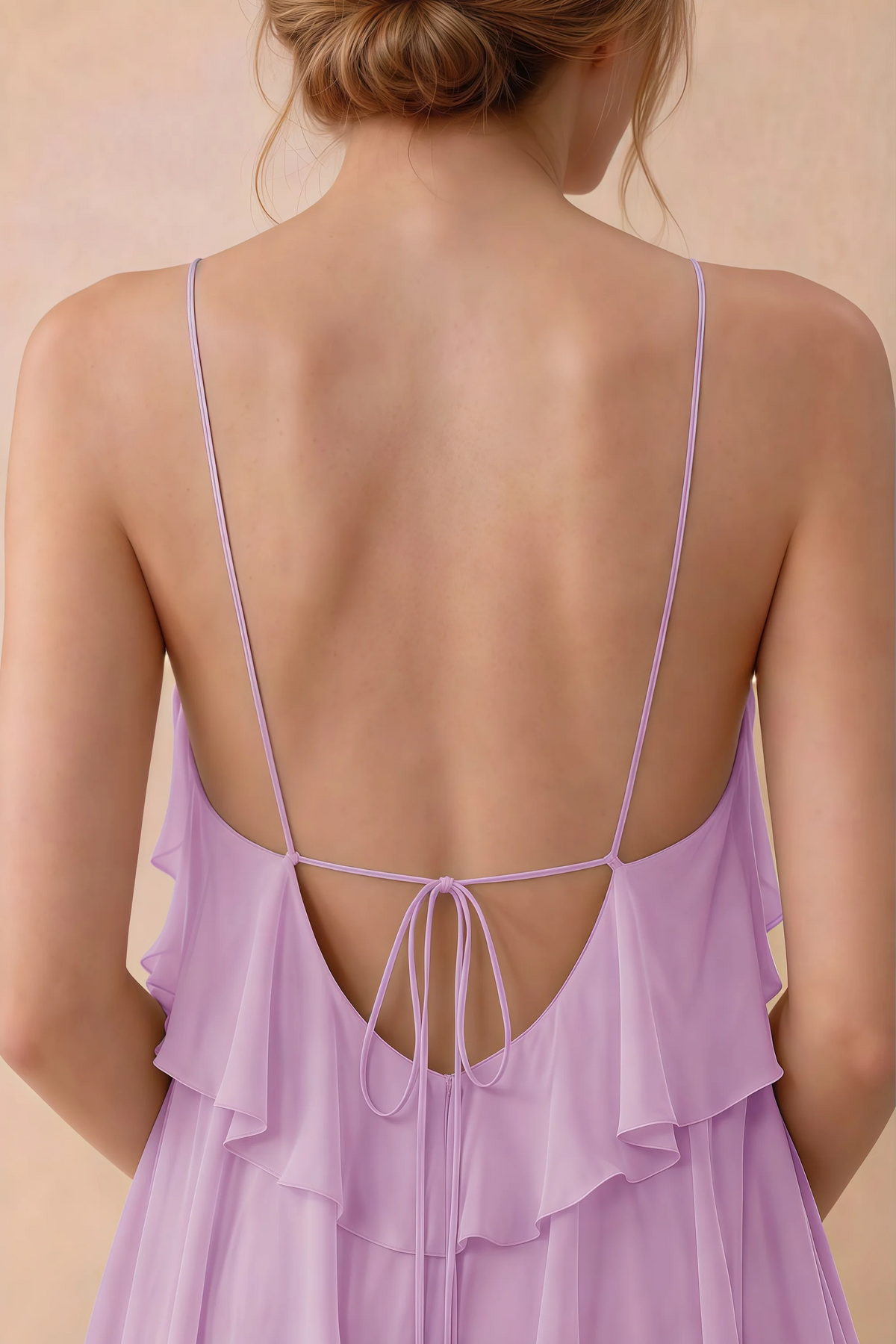 Close-up of Audrey candy open back with fine straps tied in a small bow