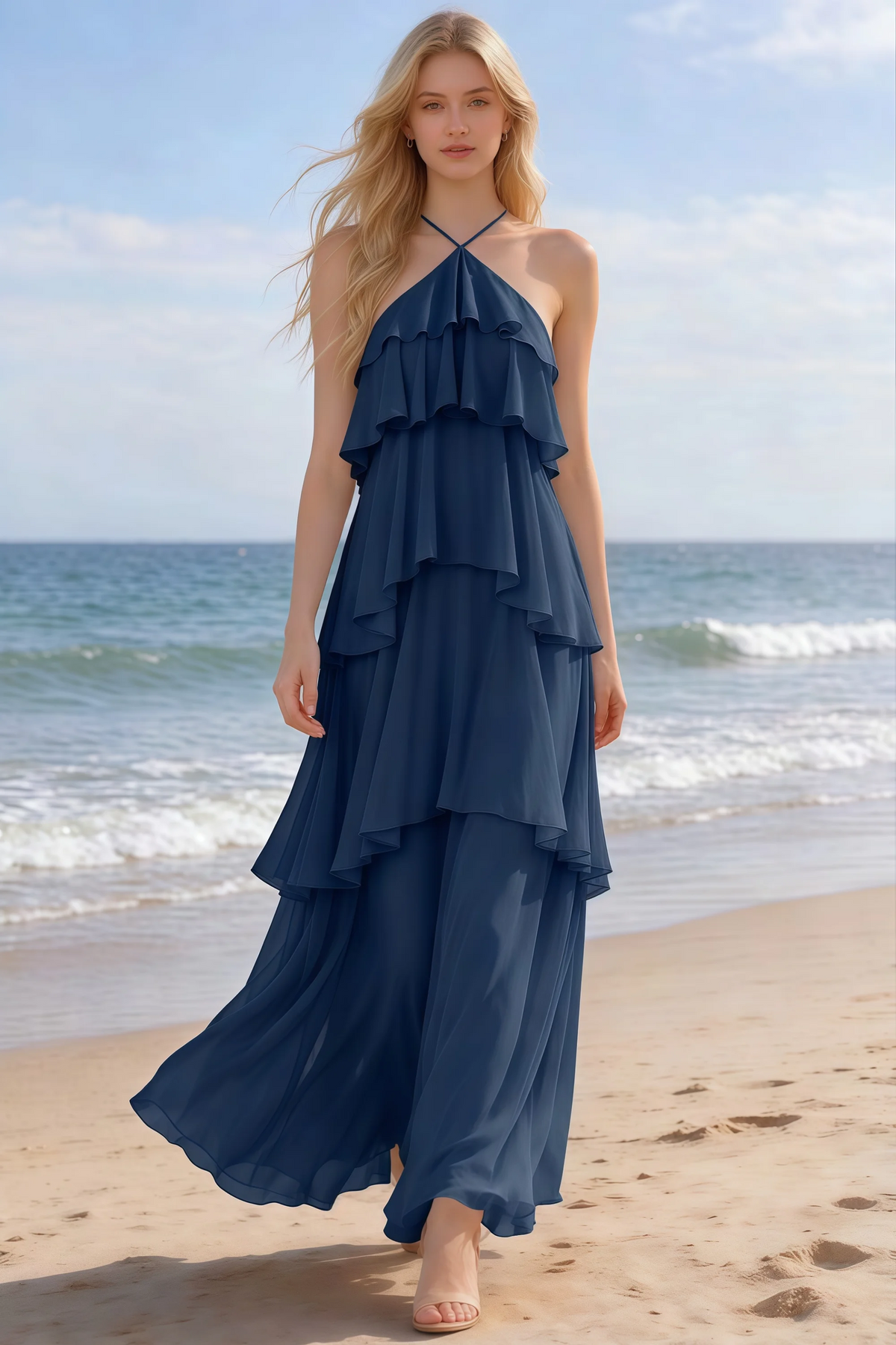 Audrey navy halter chiffon maxi dress shown from the front on a beach