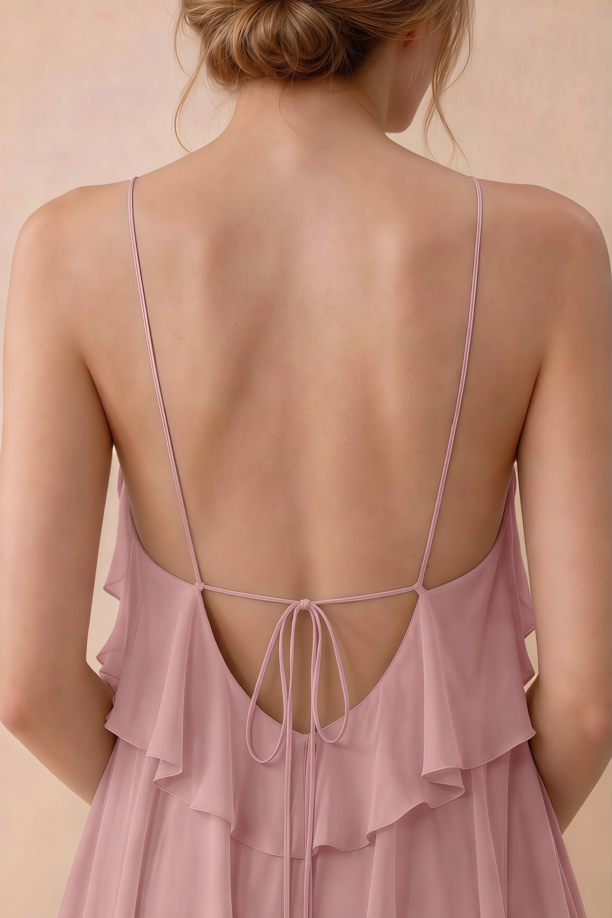 Close-up of Audrey dusty rose open back with fine straps tied in a small bow