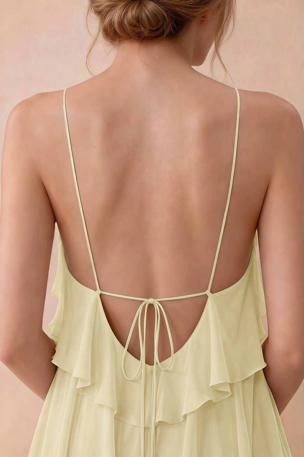 Close-up of Audrey lemon open back with fine straps tied in a small bow