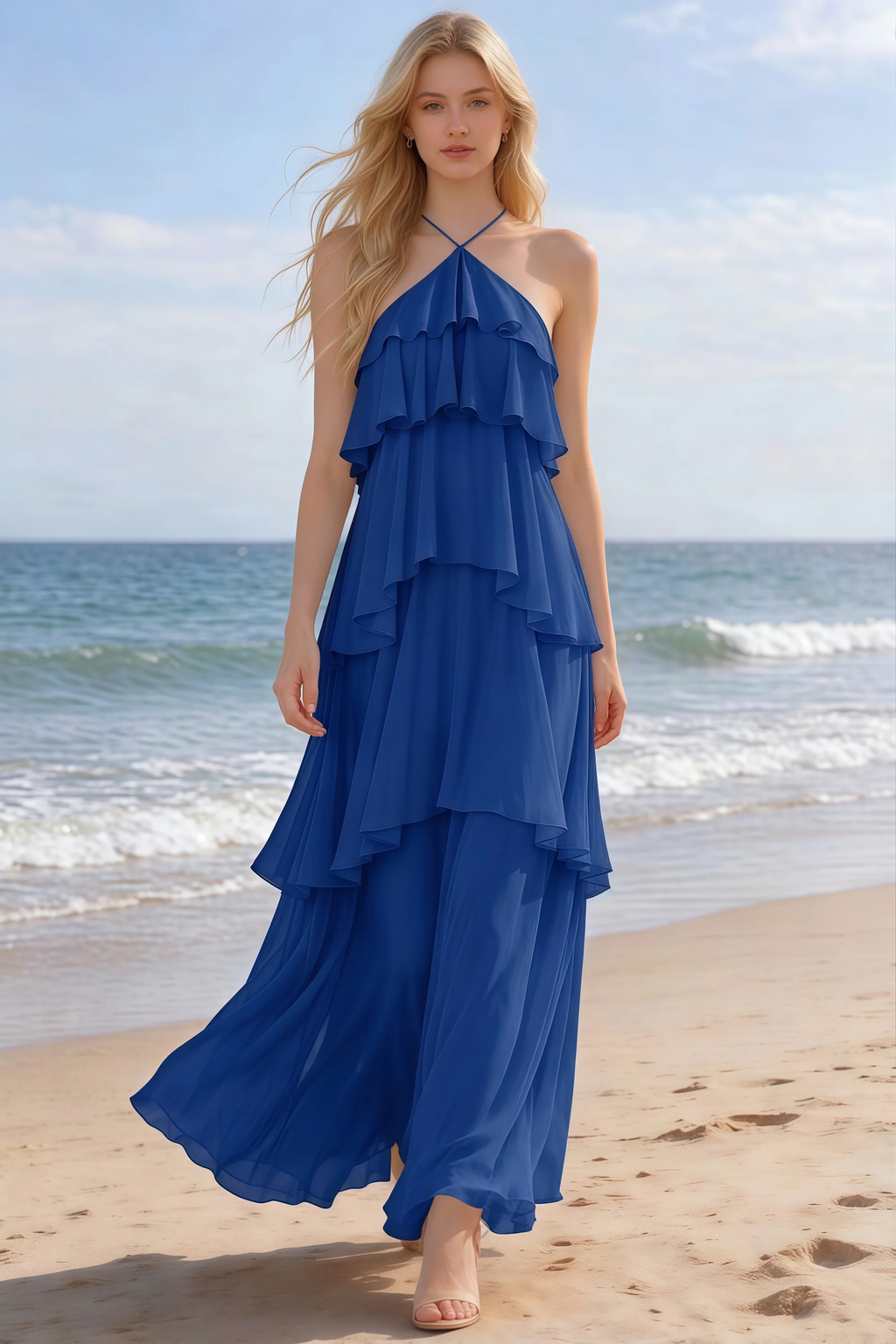 Audrey royal blue halter chiffon maxi dress shown from the front on a beach