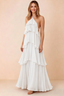 Front view of Audrey white chiffon maxi dress with crossed halter straps and cascading tiered ruffles