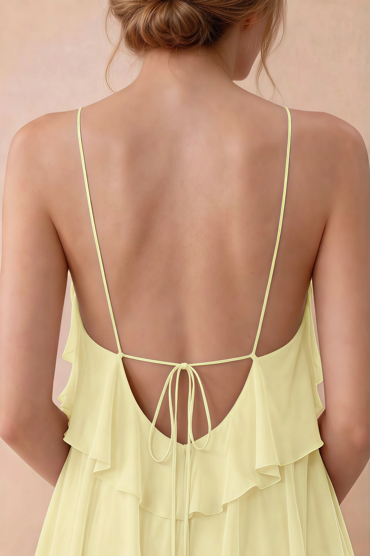 Close-up of Audrey yellow open back with fine straps tied in a small bow