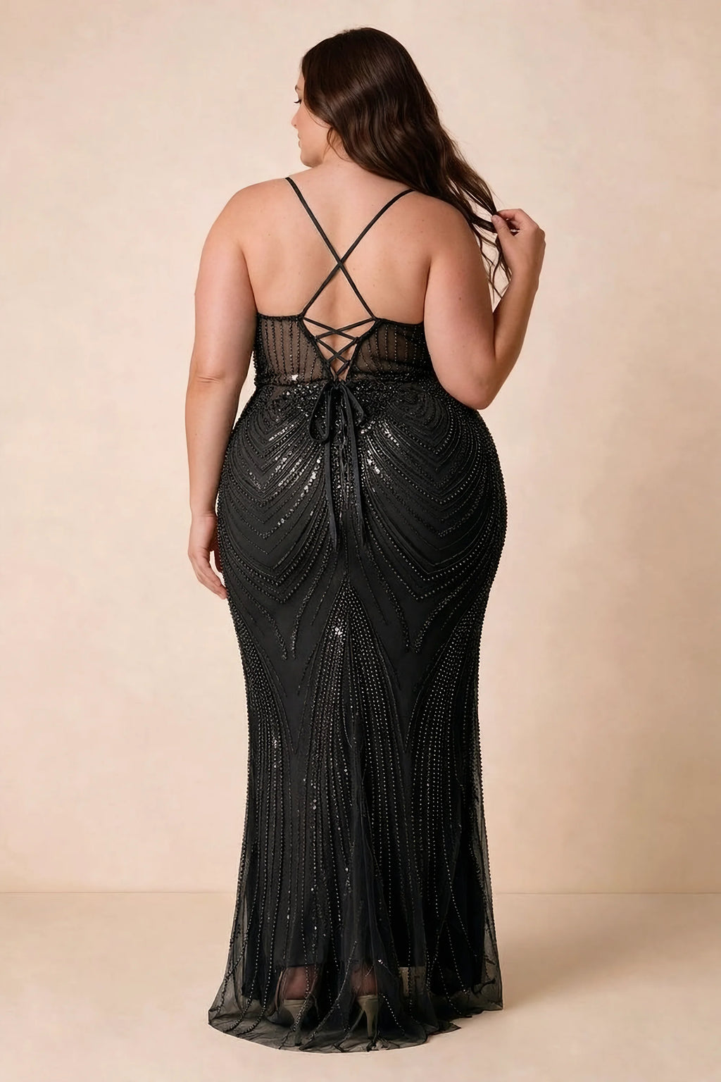 Back view on a second model of the Augusta black dress, showing crisscross straps and tie fastening.