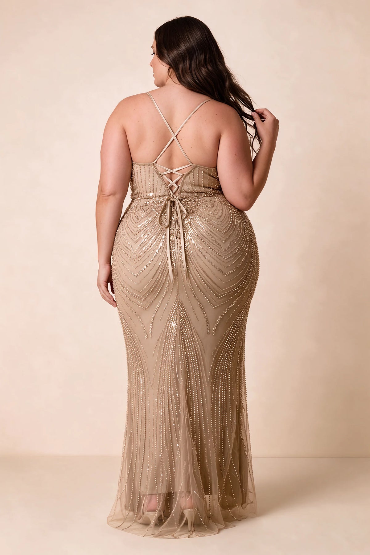 Back view on a second model of the Augusta champagne dress, showing crisscross straps and tie fastening.