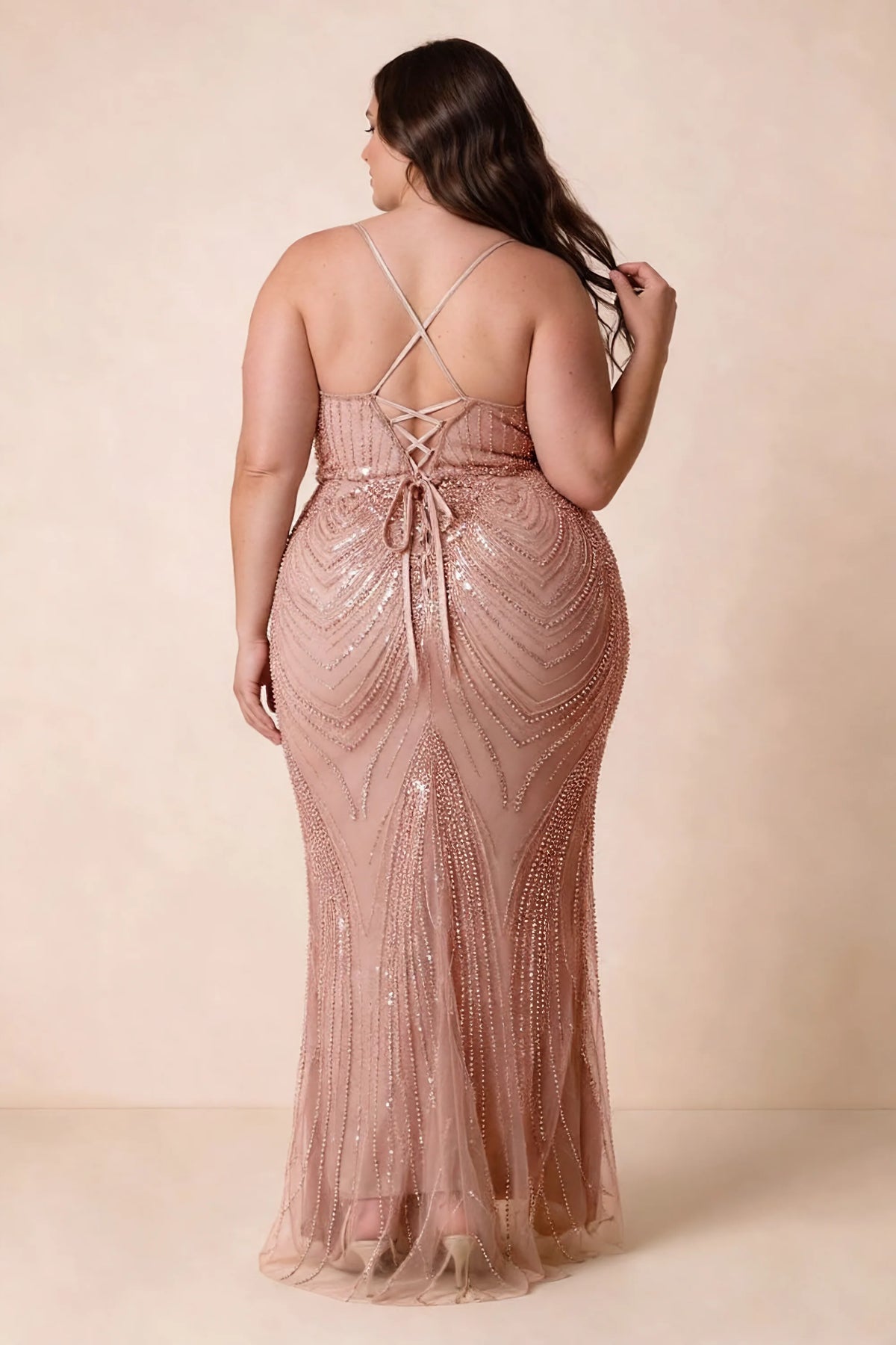 Back view on a second model of the Augusta dusty pink dress, showing crisscross straps and tie fastening.
