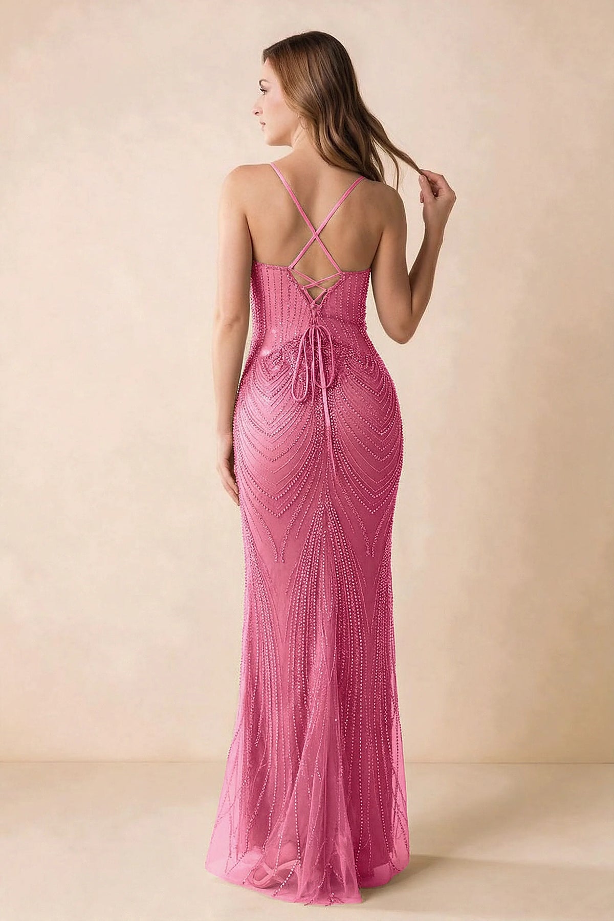 Back view of the Augusta fuchsia maxi dress showing crossed straps, lace-up ties and a flared hem.