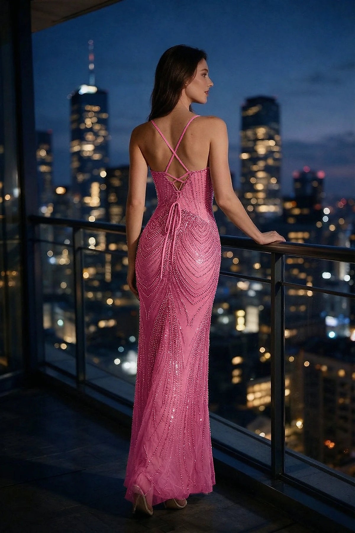 Rear view of the Augusta fuchsia mermaid dress on a balcony, showing the open lace-up back.