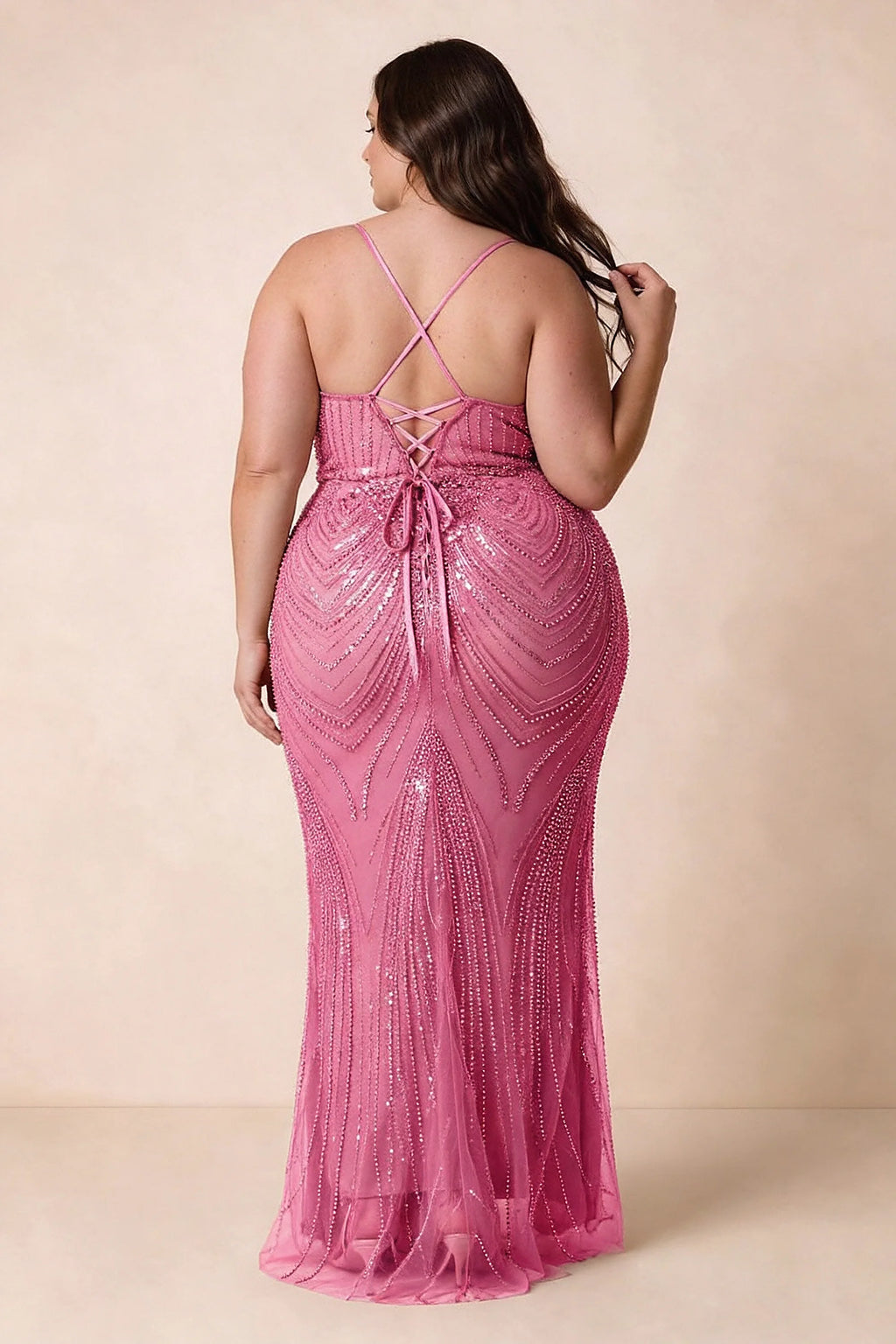 Back view on a second model of the Augusta fuchsia dress, showing crisscross straps and tie fastening.