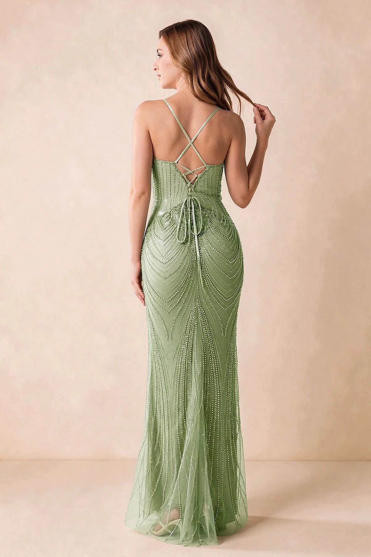 Back view of the Augusta light green maxi dress showing crossed straps, lace-up ties and a flared hem.