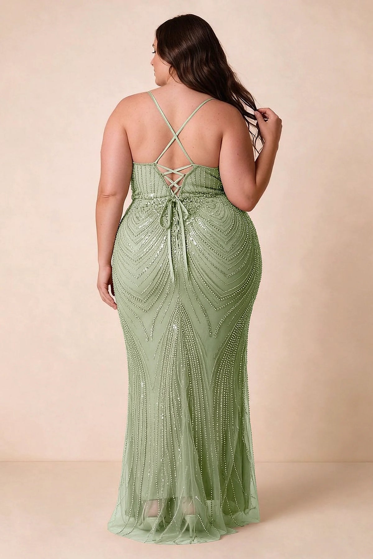 Back view on a second model of the Augusta light green dress, showing crisscross straps and tie fastening.