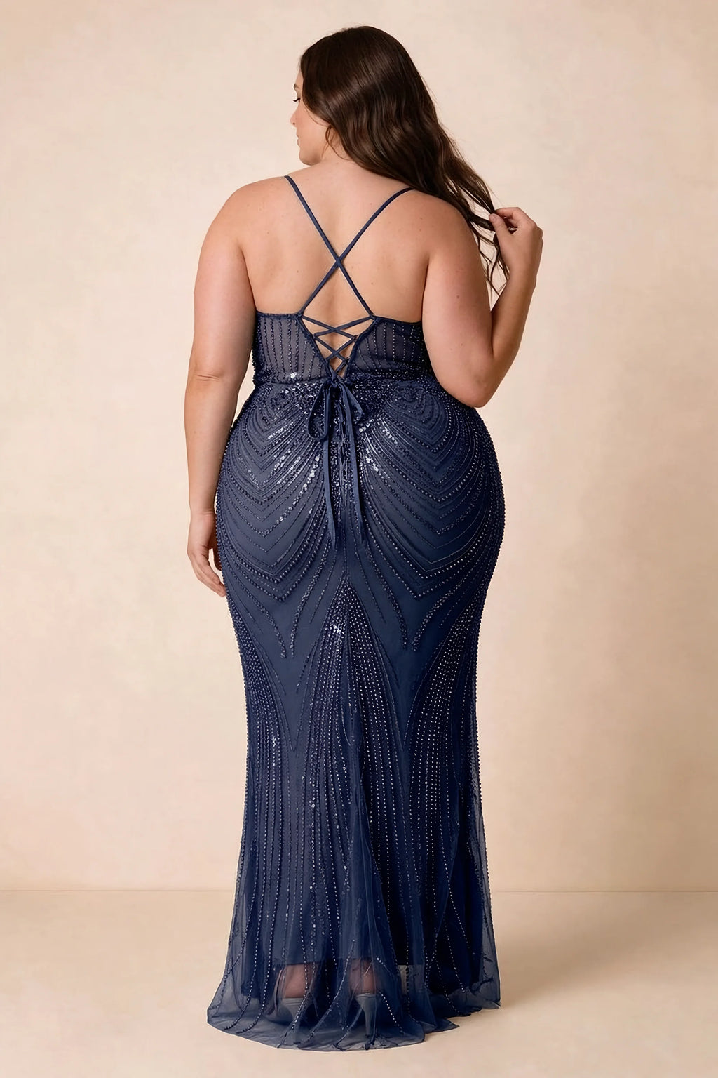 Back view on a second model of the Augusta navy dress, showing crisscross straps and tie fastening.