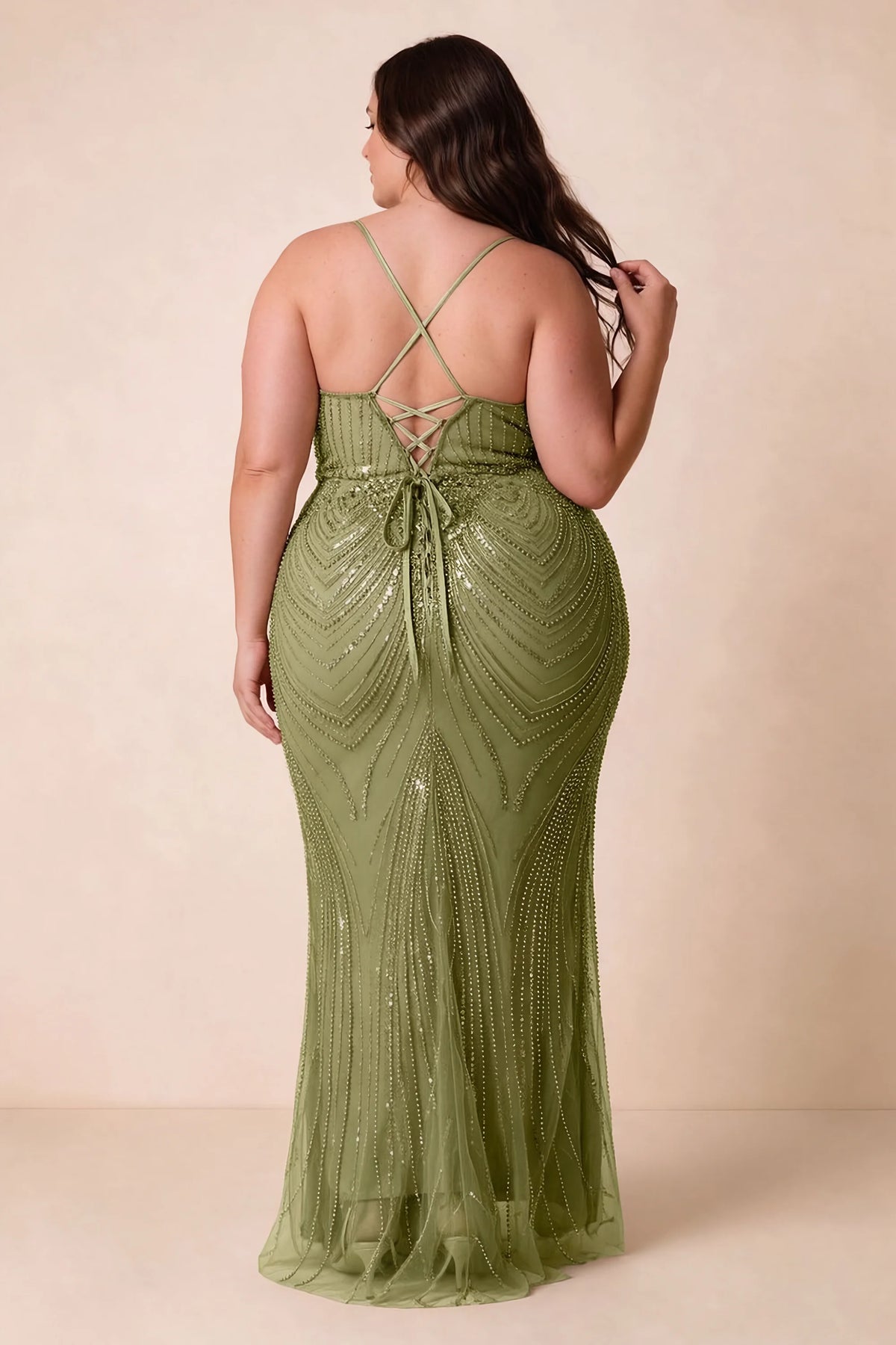Back view on a second model of the Augusta olive dress, showing crisscross straps and tie fastening.