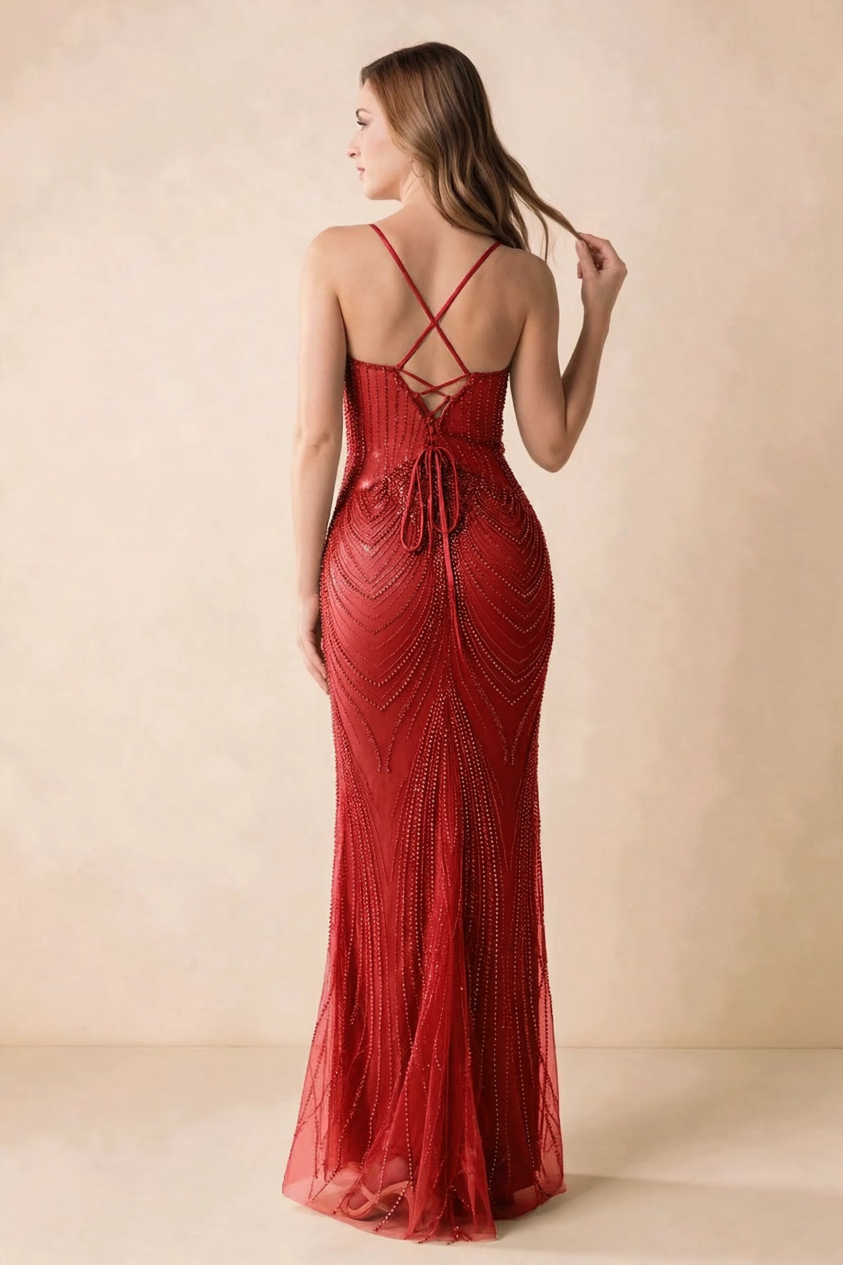 Back view of the Augusta red maxi dress showing crossed straps, lace-up ties and a flared hem.