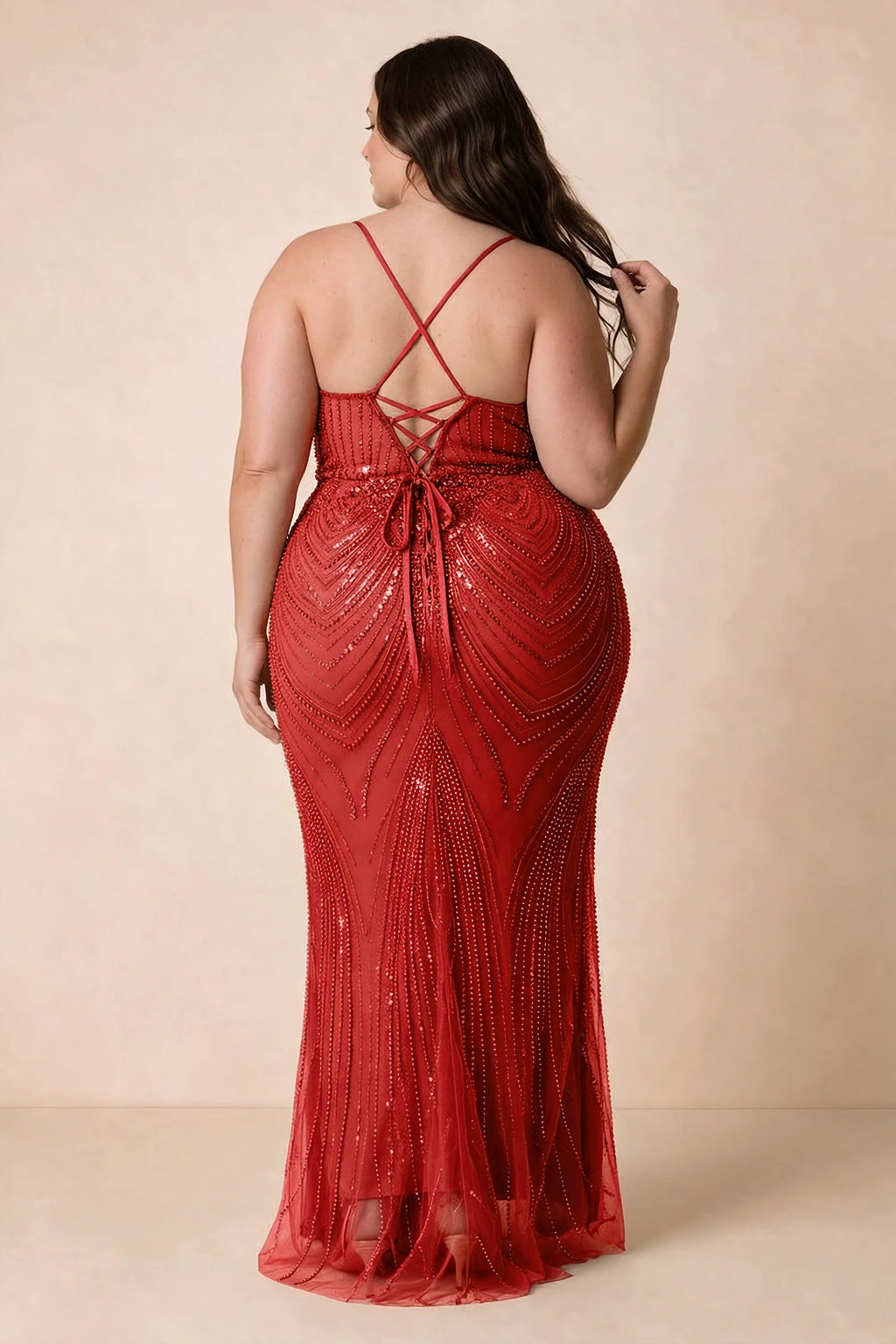 Back view on a second model of the Augusta red dress, showing crisscross straps and tie fastening.