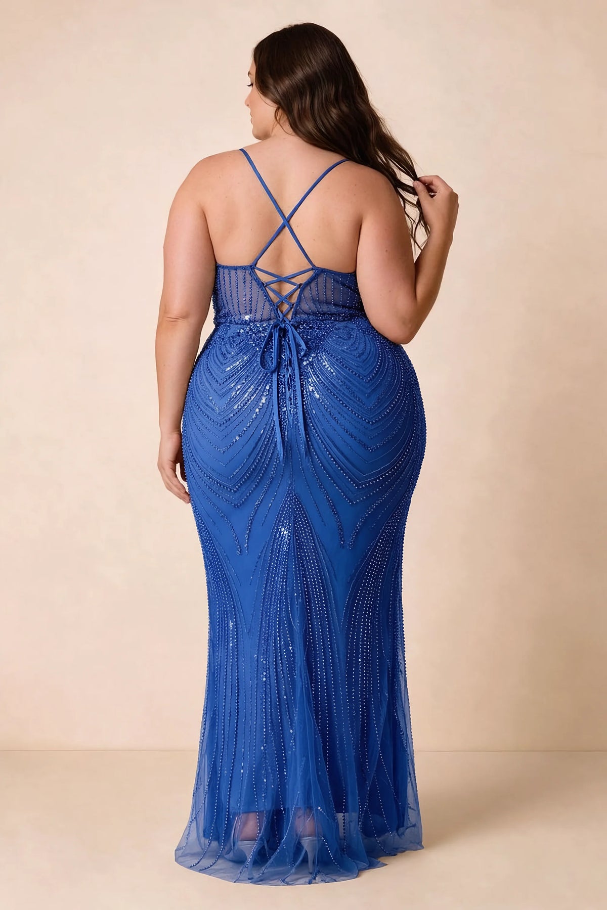 Back view on a second model of the Augusta royal blue dress, showing crisscross straps and tie fastening.