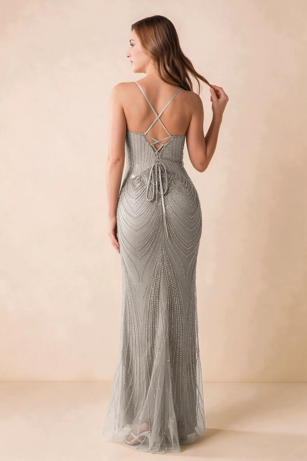Back view of the Augusta silver maxi dress showing crossed straps, lace-up ties and a flared hem.