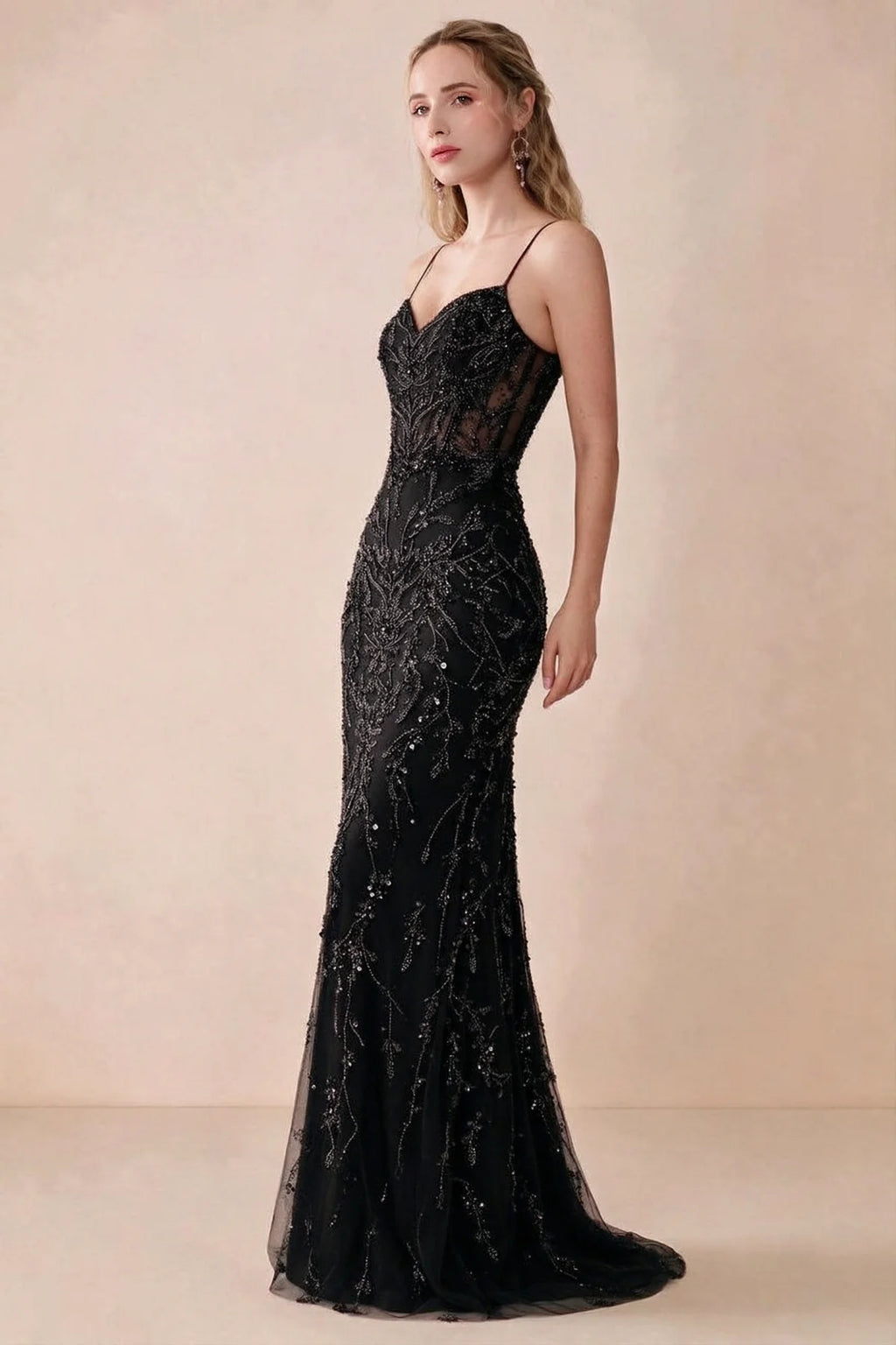 Side view of Aurelia black sequin maxi dress showing the fitted hips and flared hem