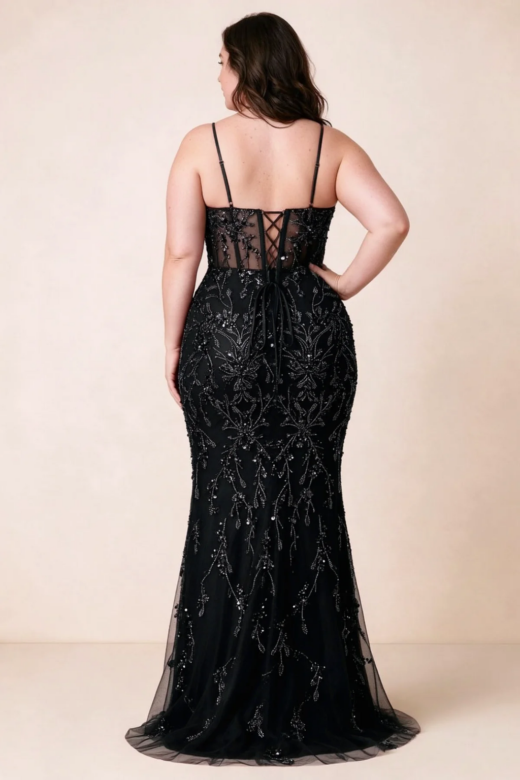 Back view on a second model showing the Aurelia black corset dress and waist lacing