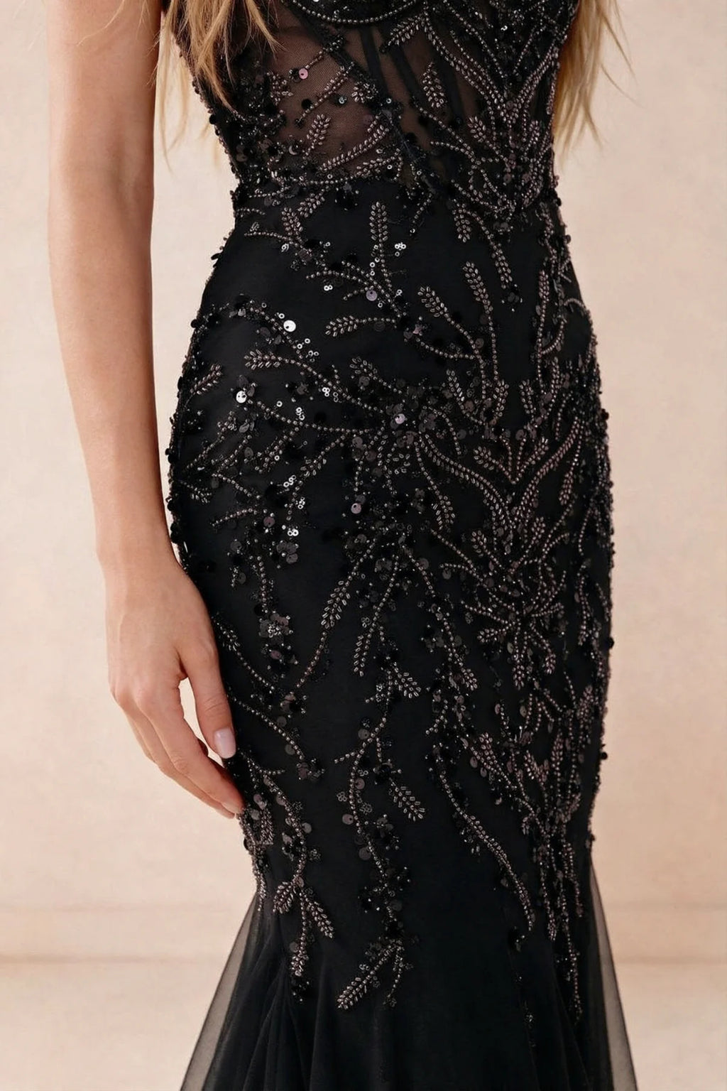 Detail of Aurelia black embroidered sequin pattern across the fitted waist and hip