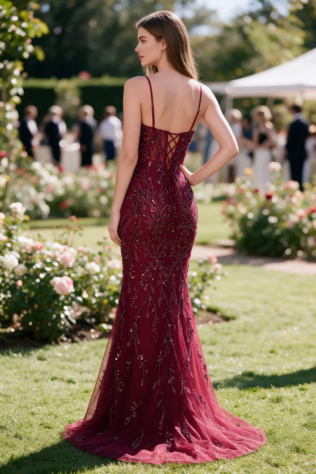 Rear garden view of Aurelia burgundy mermaid dress with an open upper back and lace-up waist