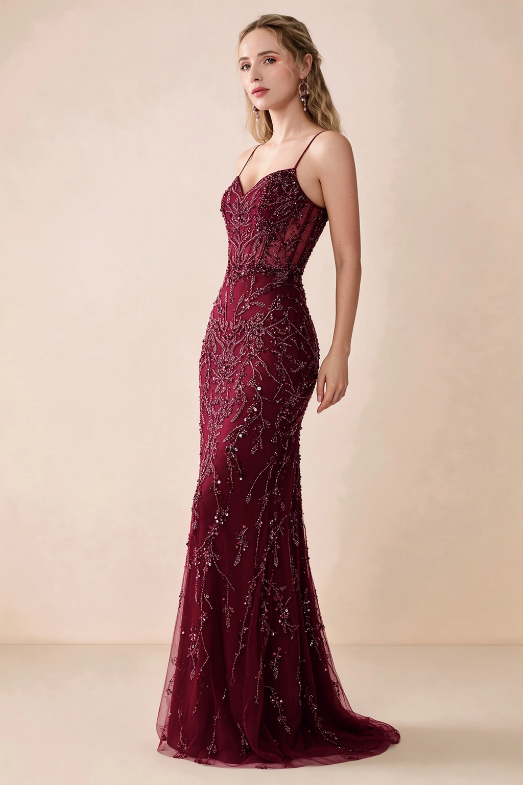Side view of Aurelia burgundy sequin maxi dress showing the fitted hips and flared hem