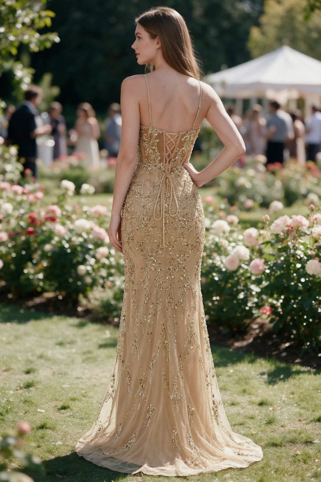 Rear garden view of Aurelia champagne mermaid dress with an open upper back and lace-up waist