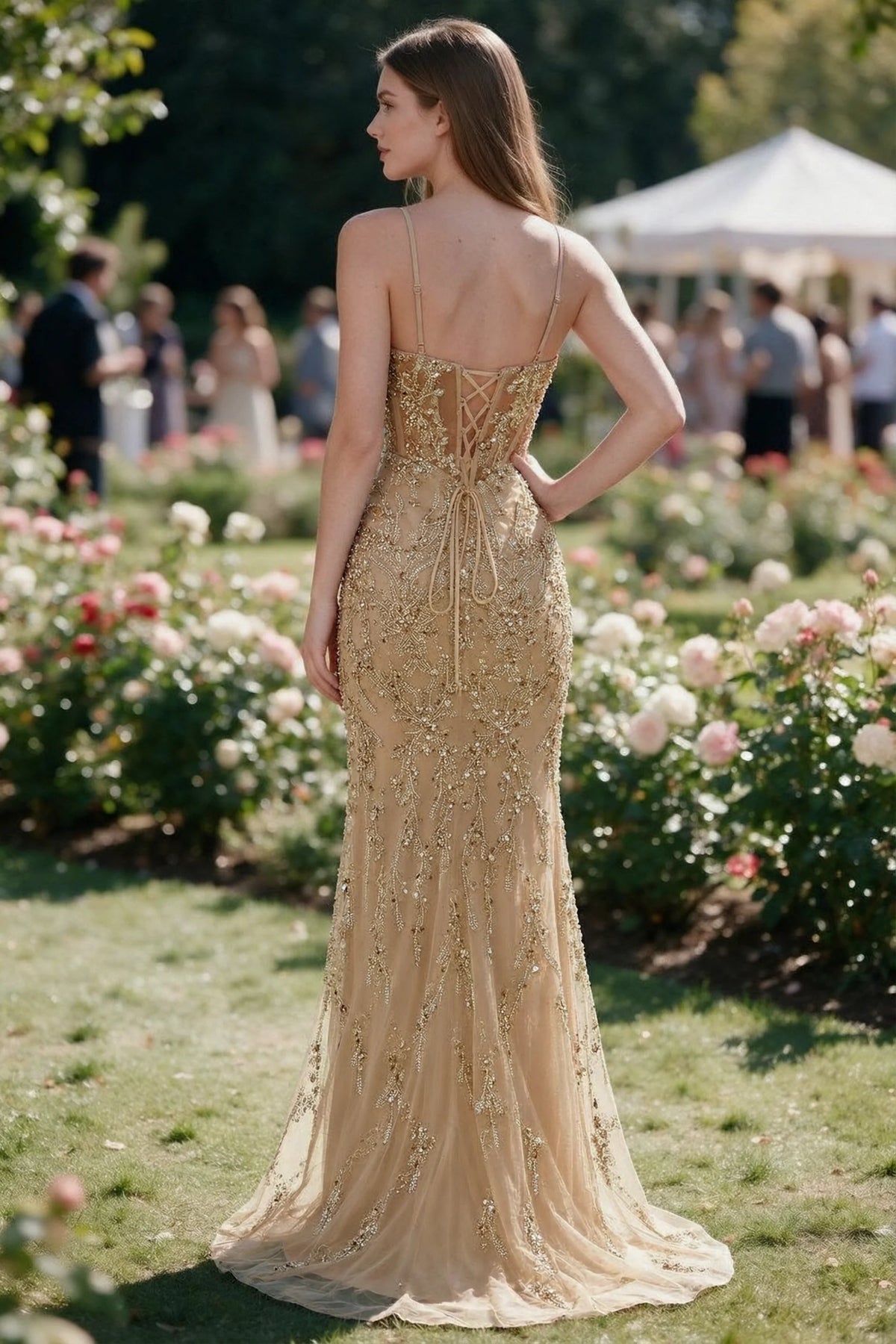 Rear garden view of Aurelia champagne mermaid dress with an open upper back and lace-up waist