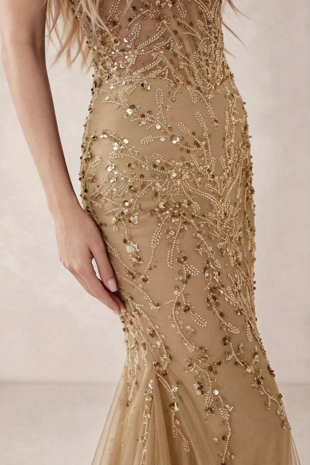 Detail of Aurelia champagne embroidered sequin pattern across the fitted waist and hip