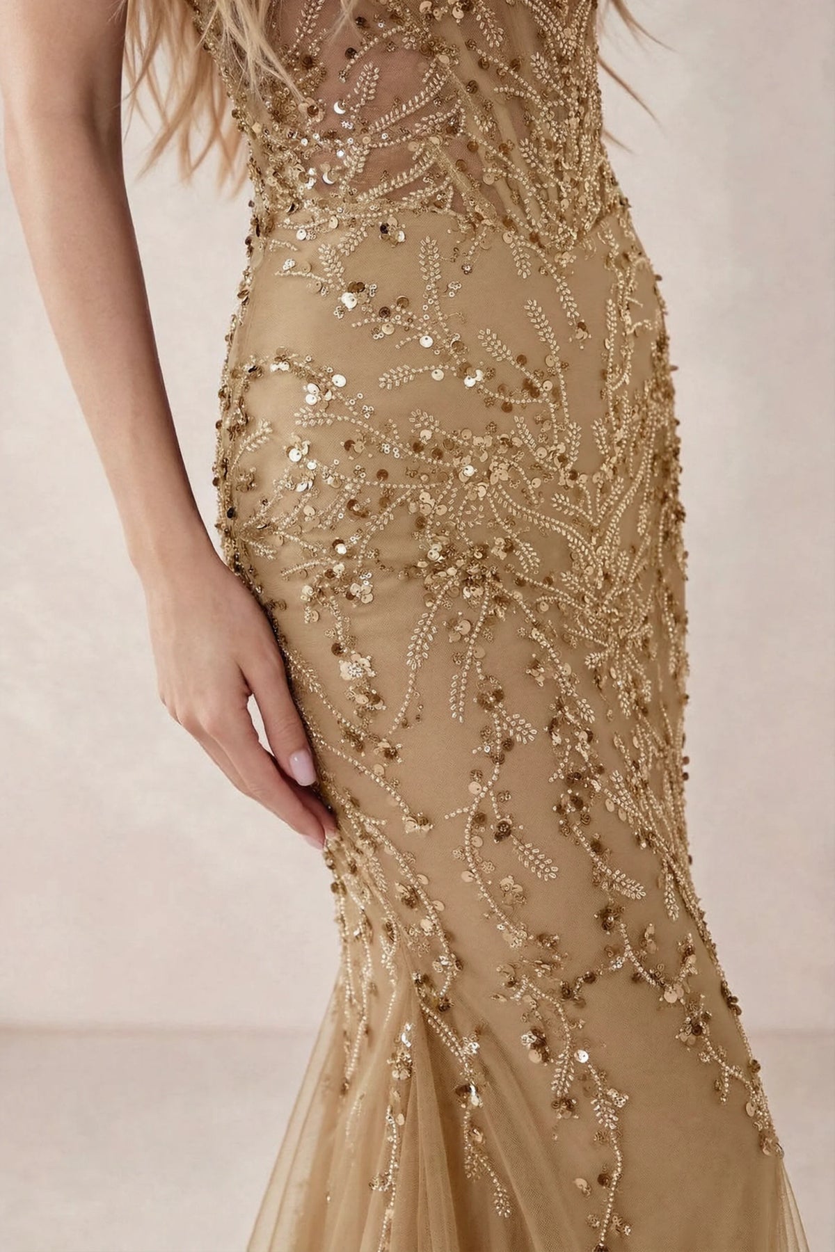Detail of Aurelia champagne embroidered sequin pattern across the fitted waist and hip