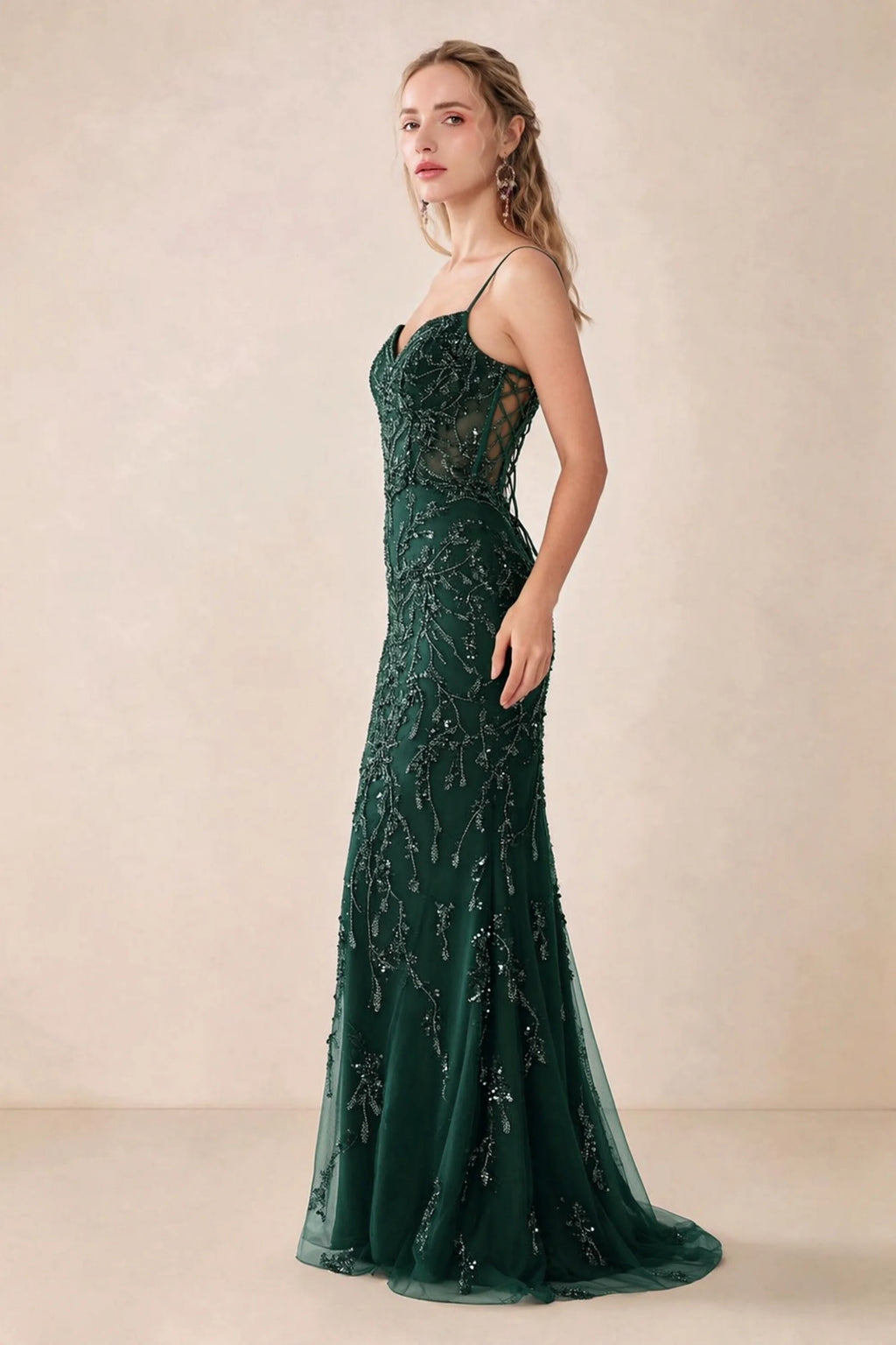 Side view of Aurelia dark green sequin maxi dress showing the fitted hips and flared hem