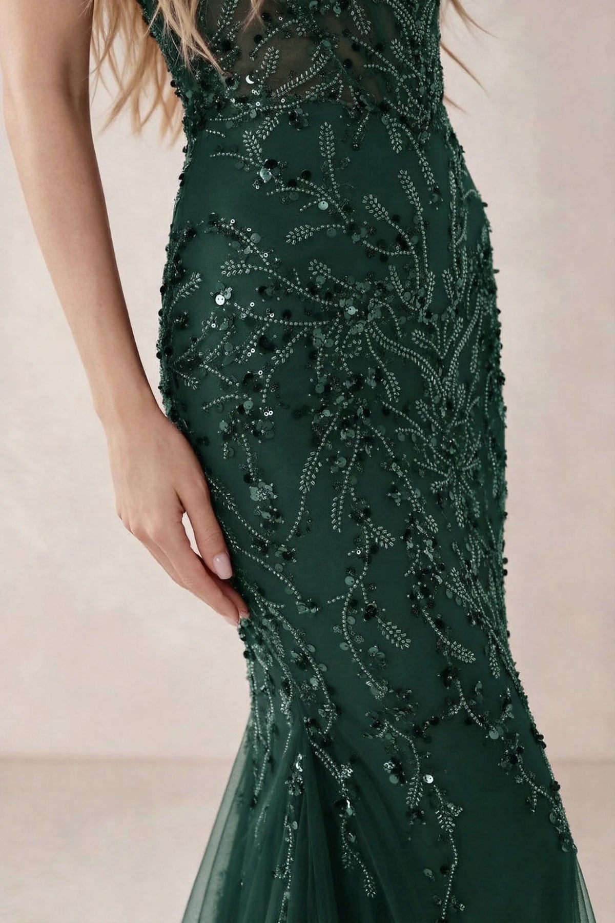 Detail of Aurelia dark green embroidered sequin pattern across the fitted waist and hip