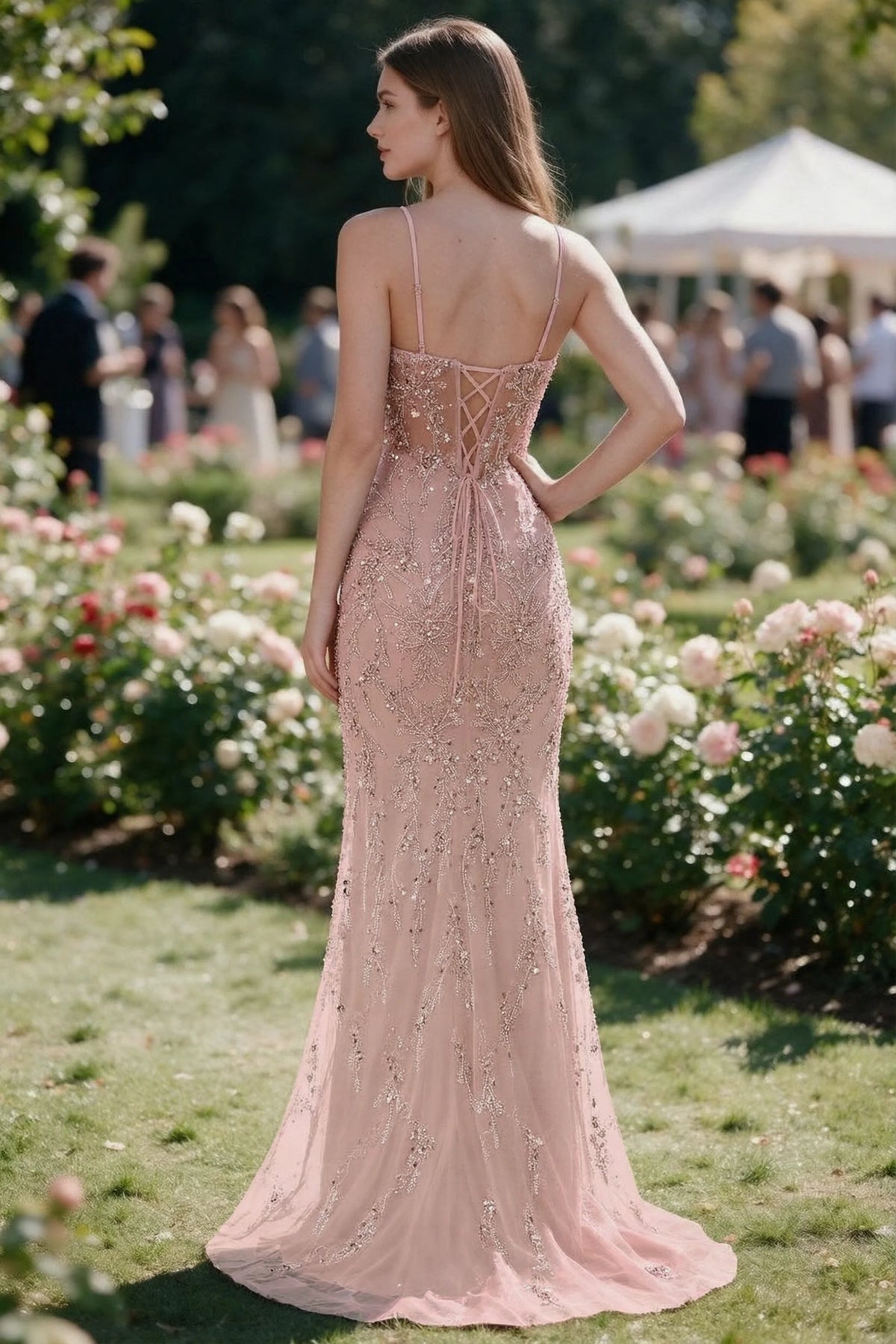 Rear garden view of Aurelia light pink mermaid dress with an open upper back and lace-up waist